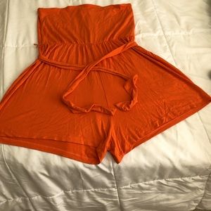 Orange tube romper with belt.
